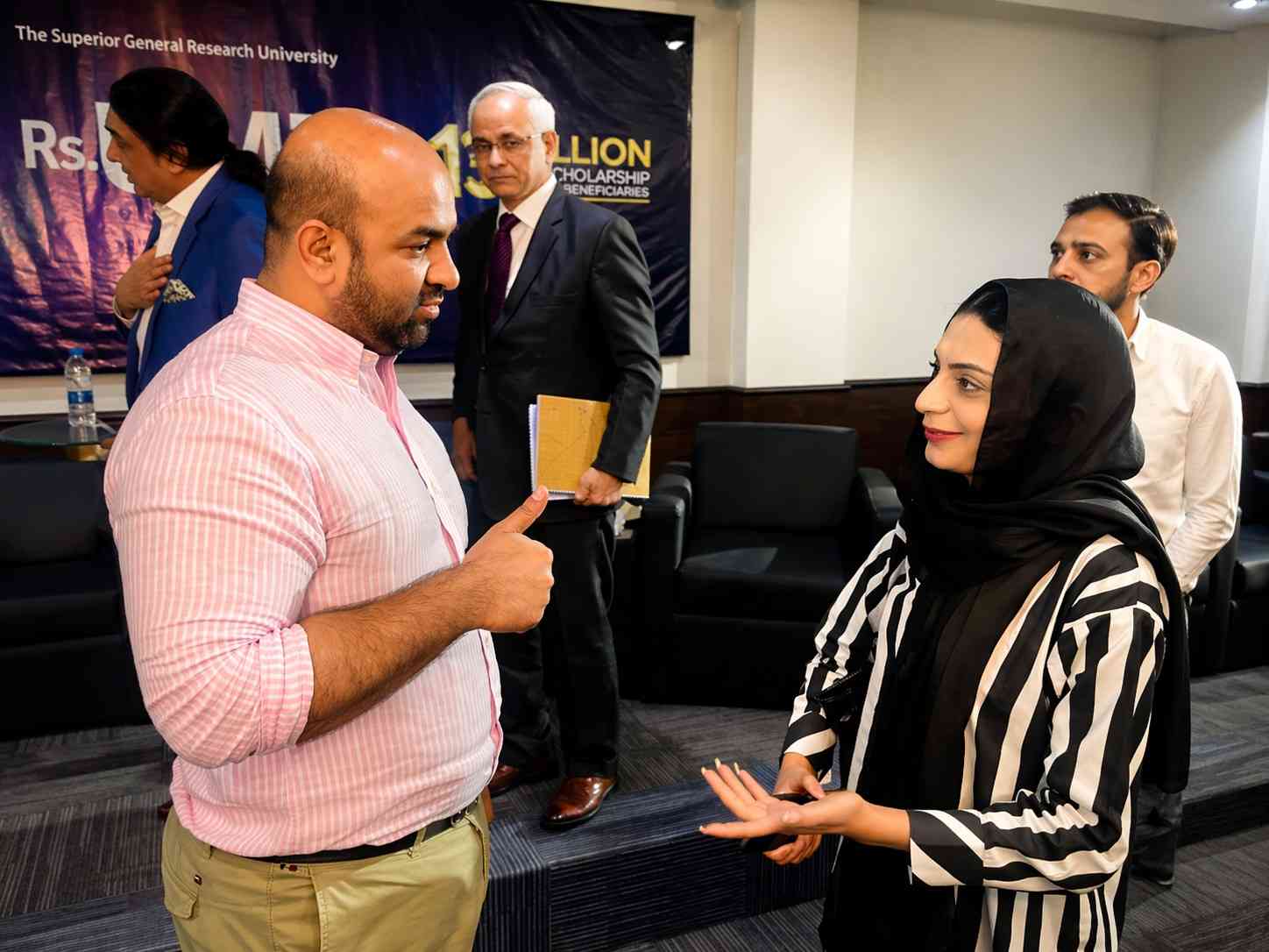 Rana Sikandar Hayat speaking with an education stakeholder at a university event